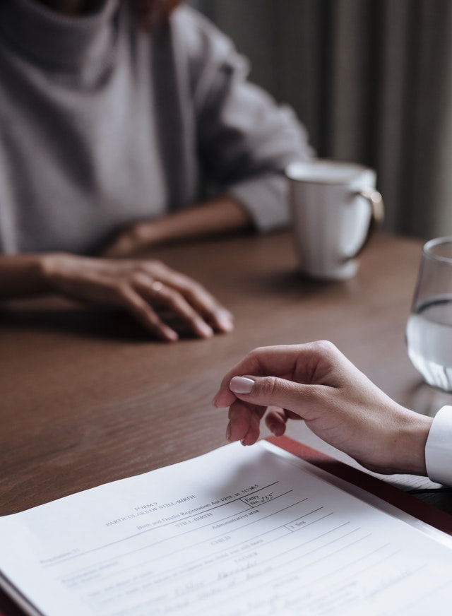 An immigration lawyer helping their client fill out the immigration form