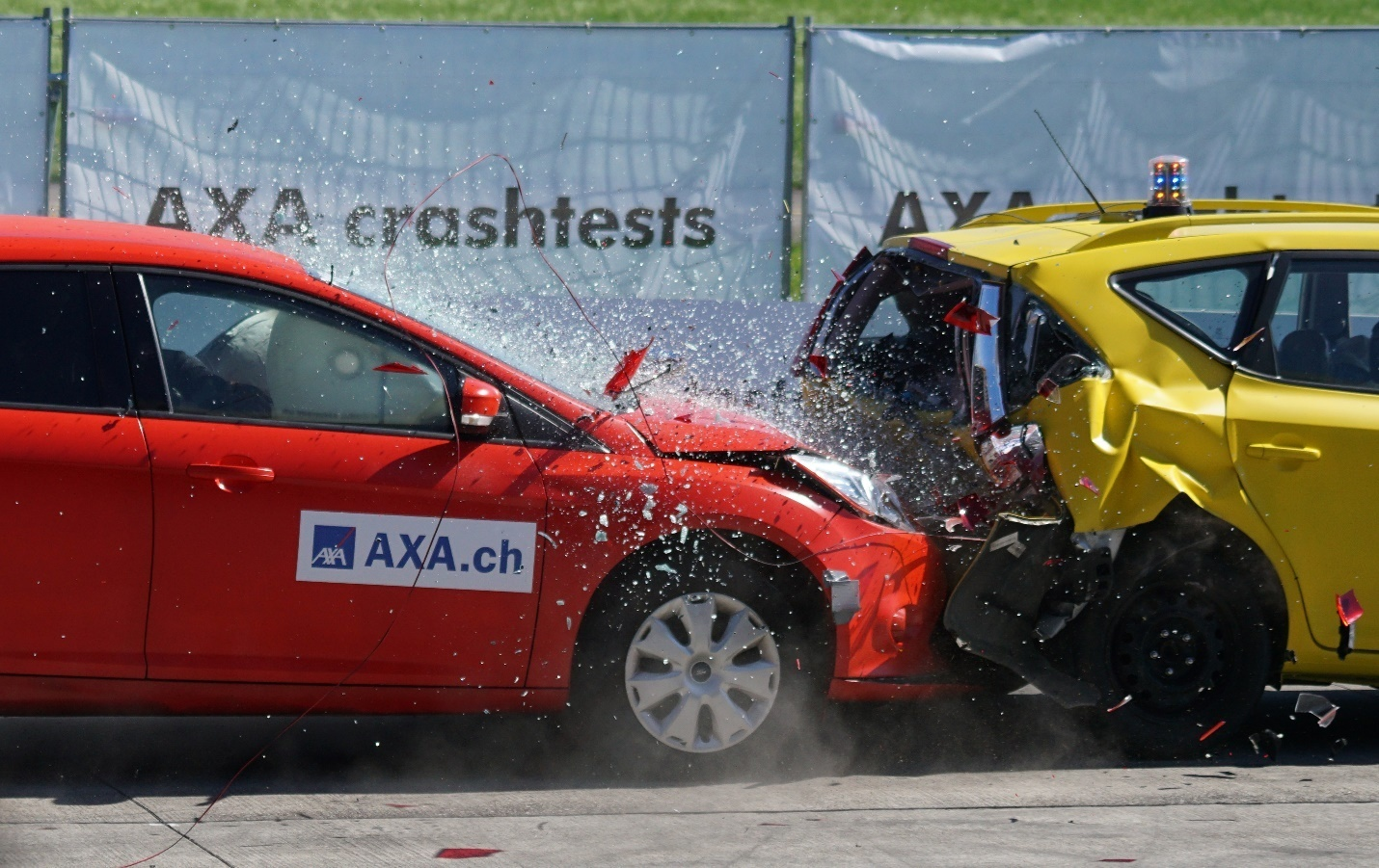 Red car crashing into a yellow car.