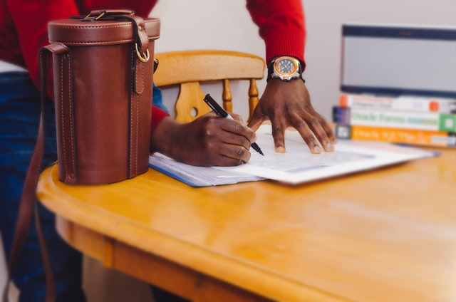A person signing papers