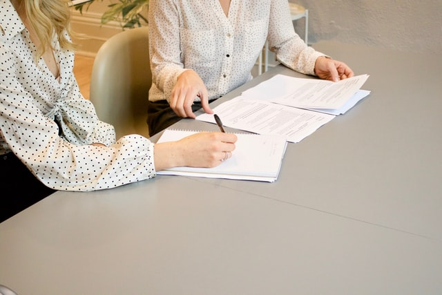 A woman signing documents
