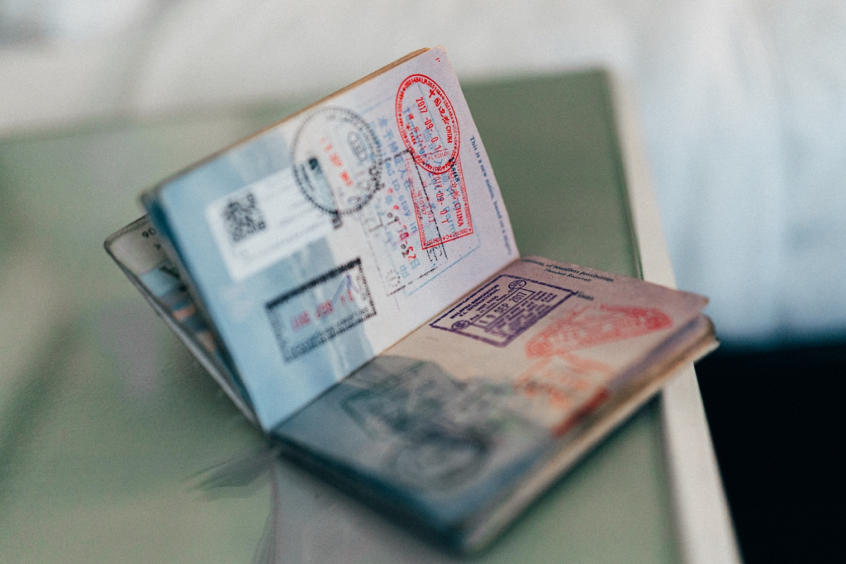 Open passport with various travel stamps