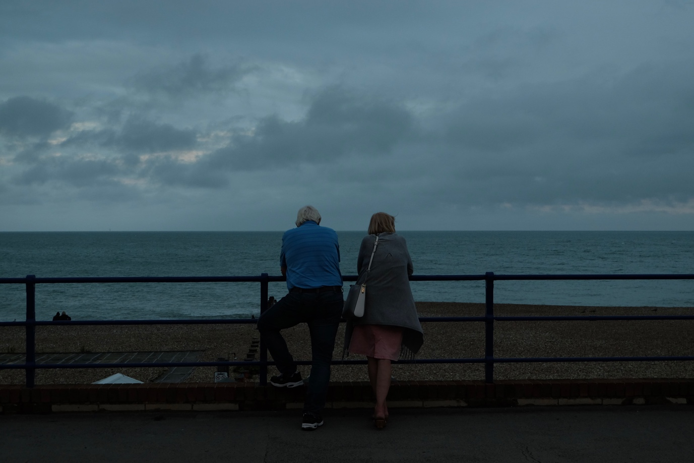 Nanda & Associate Lawyers Canada - Elderly man and woman overlooking the sea on a cloudy evening