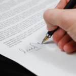 Nanda & Associate Lawyers Canada - A person signing a construction contract