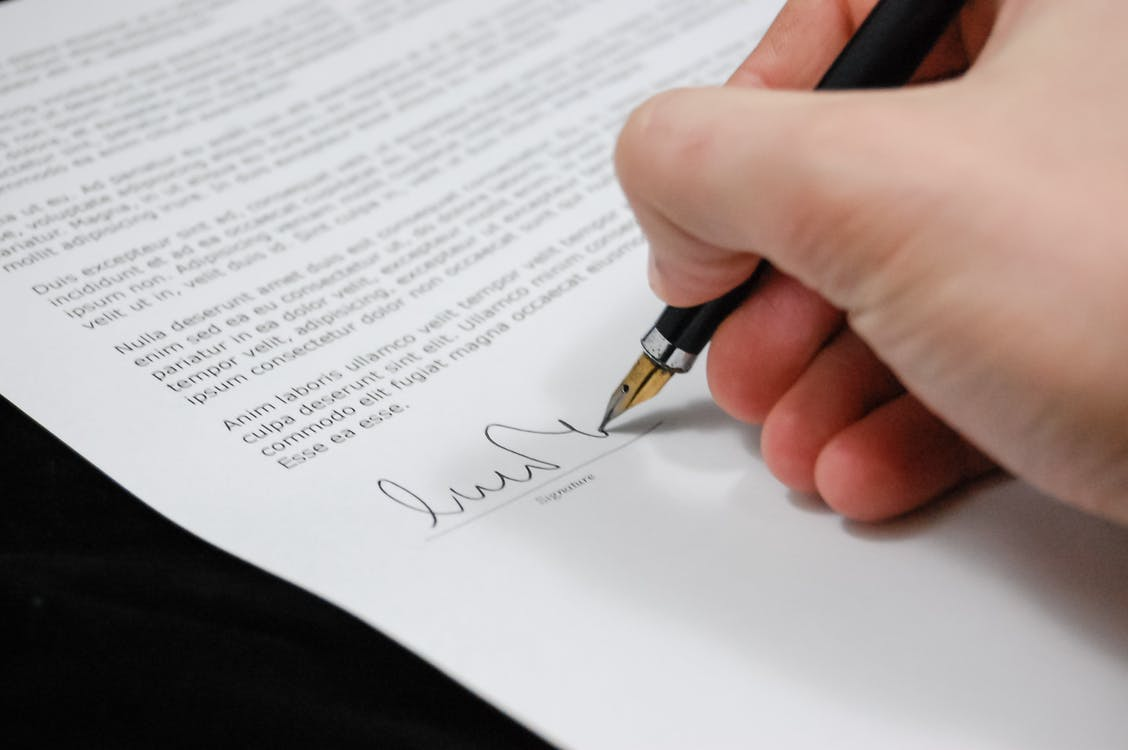 Nanda & Associate Lawyers Canada - A person signing a construction contract
