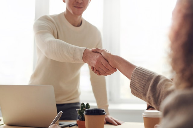 A property lawyer shaking hands with a client