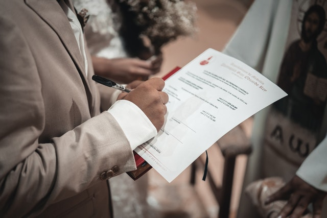 A groom signing a marriage contract