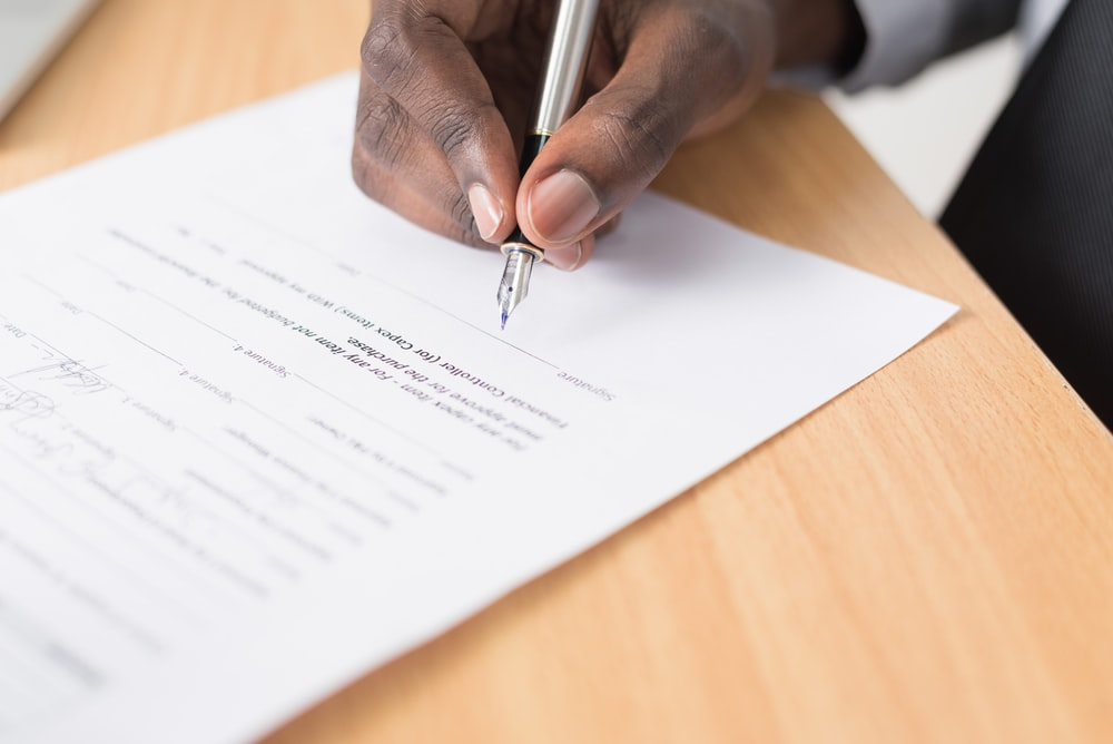 A man signing legal documents