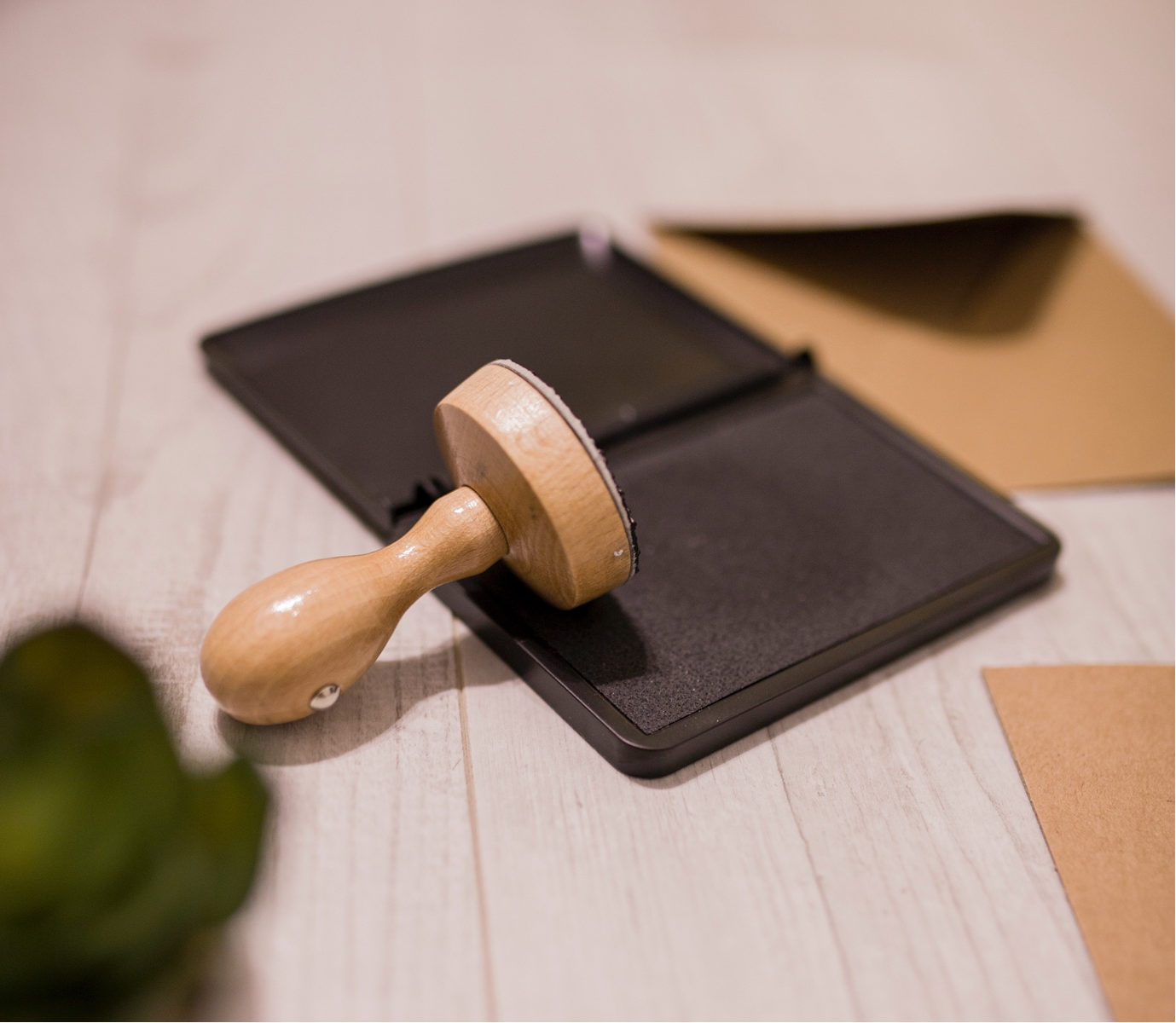 Wooden stamp on top of a black ink pad