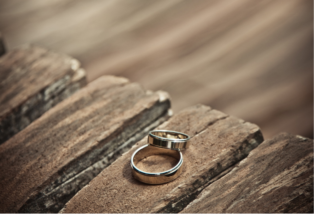 Wedding rings on a wooden bench