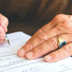 Nanda & Associate Lawyers Canada - An older person signing documents