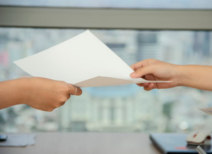 A person handing over a document