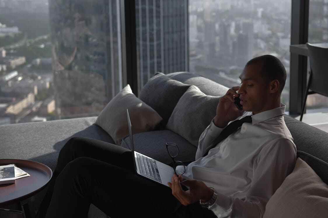 A businessman consulting with their lawyer on call.