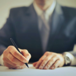 Nanda & Associate Lawyers Canada - man-signing-on-paper