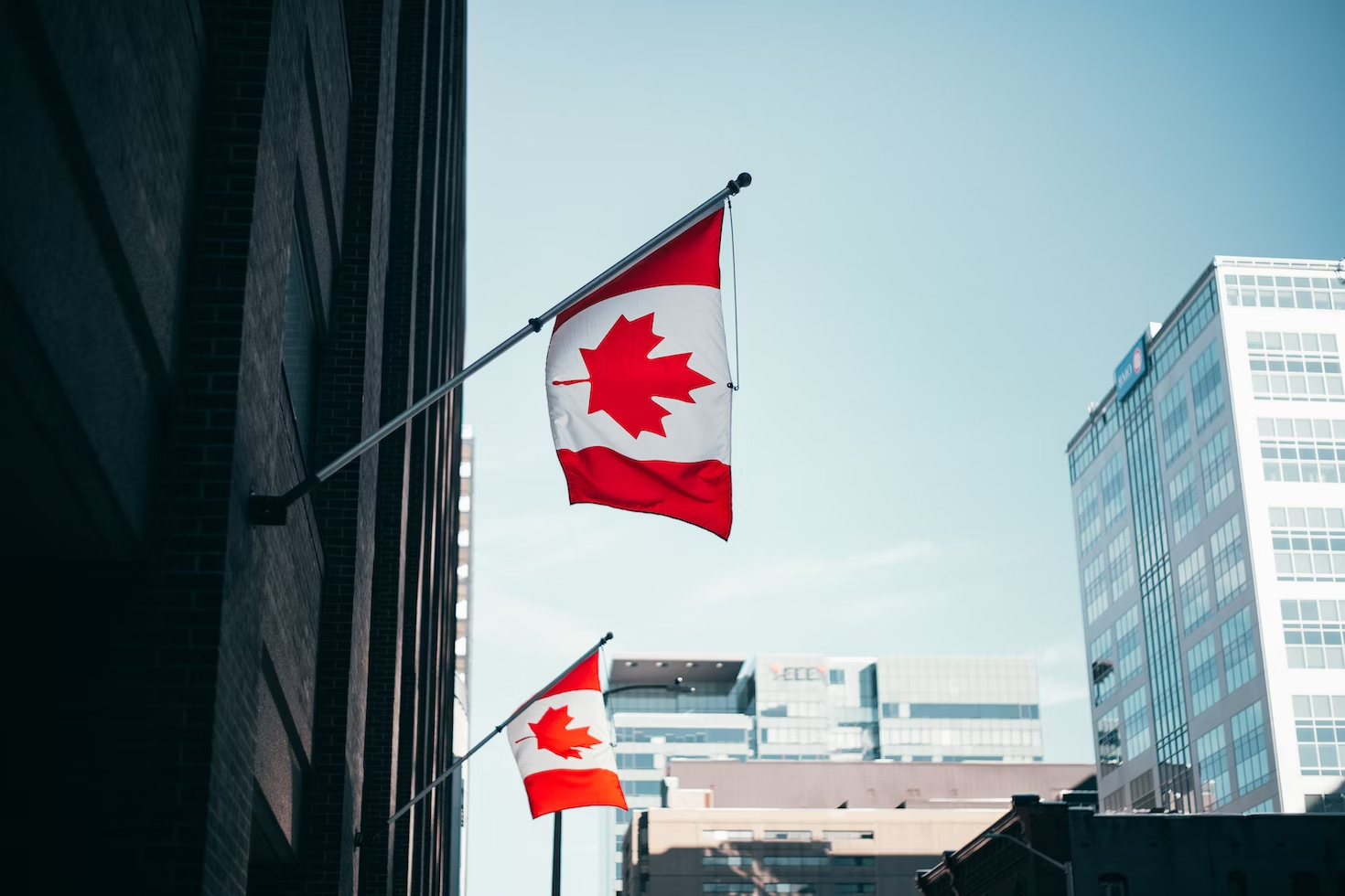 Nanda & Associate Lawyers Canada - An image of Canada’s flags on a building