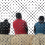 Nanda & Associate Lawyers Canada - Three people behind a cage wall